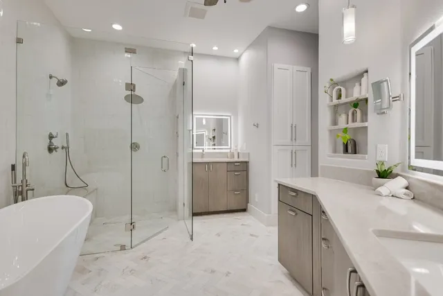 a white bath tub sitting next to a shower