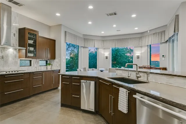 a kitchen with stainless steel appliances a stove sink and refrigerator
