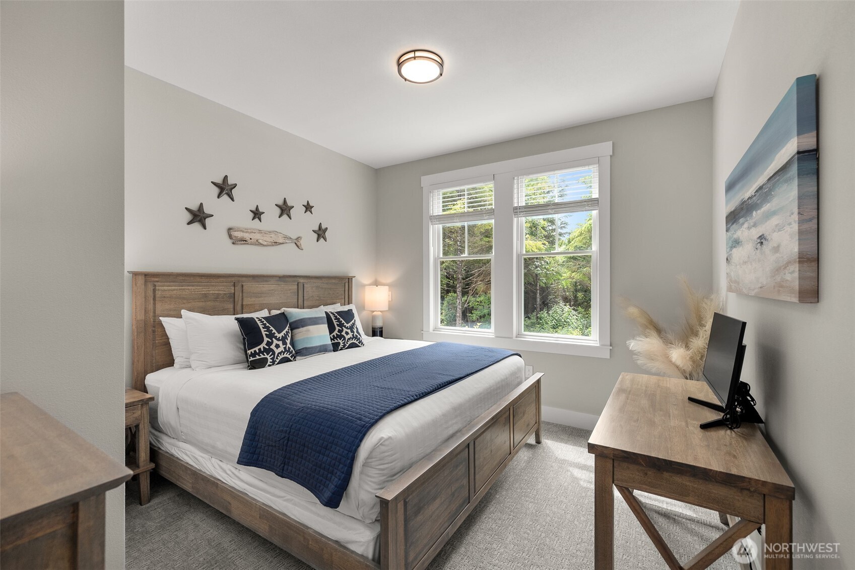 37 Elk Creek Road Raymond, WA 98577 - Photo 12 of 26 a bedroom with a large bed and a window