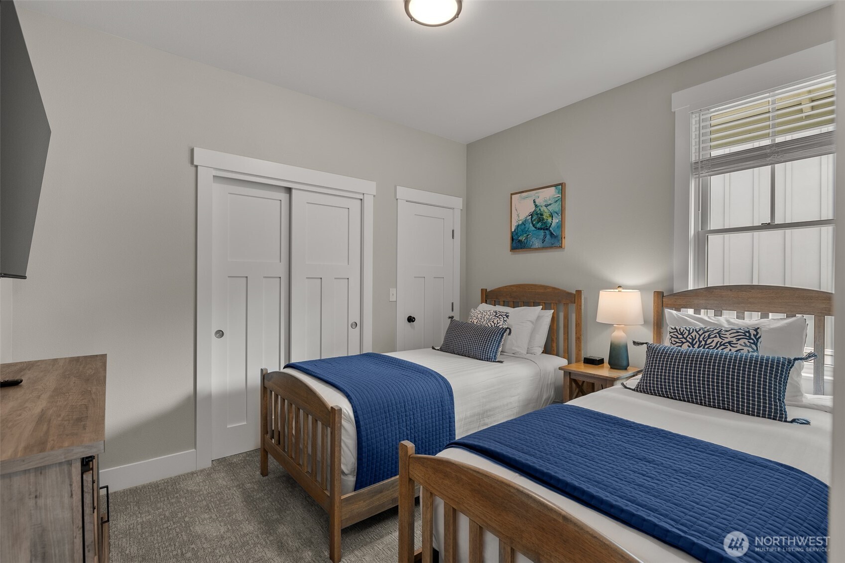 37 Elk Creek Road Raymond, WA 98577 - Photo 15 of 26 a bedroom with two beds and a lamp