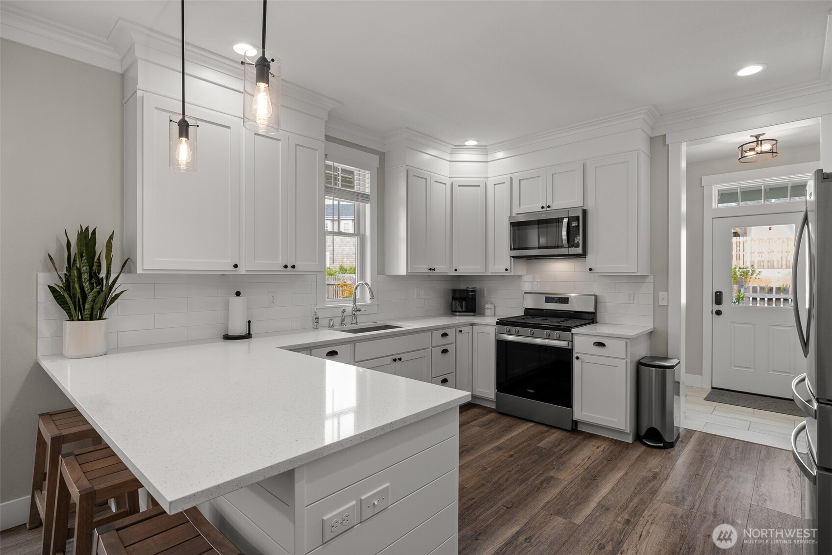 37 Elk Creek Road Raymond, WA 98577 - Photo 6 of 26 a kitchen with a stove a sink a microwave a refrigerator and cabinets
