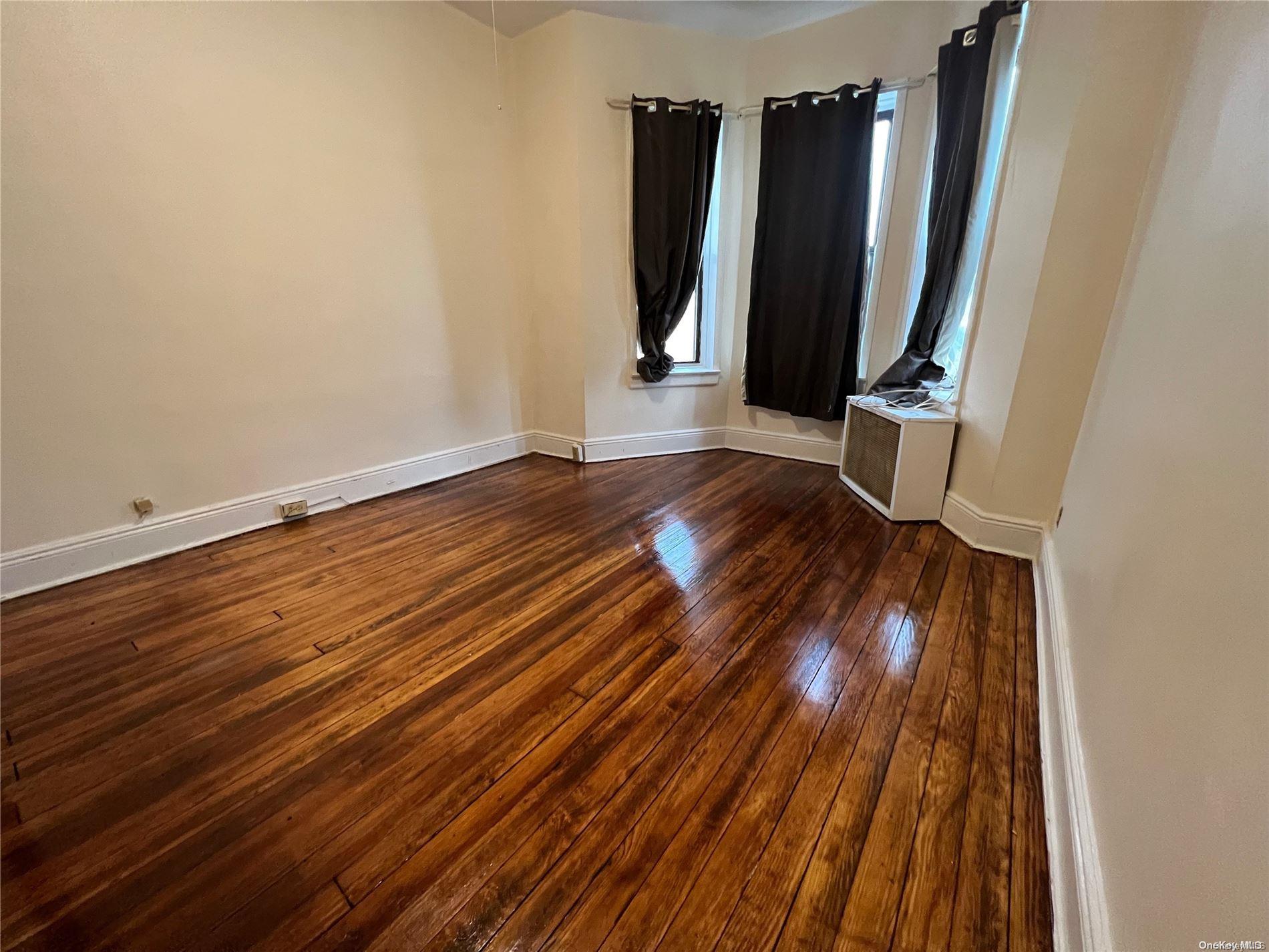 368 Eldert Lane Brooklyn, NY 11208 - Photo 6 of 10 a view of a room with wooden floor and glass doors