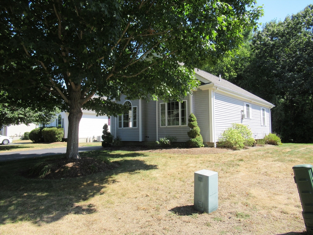 25 Rodeo Drive East Bridgewater, MA 02333 - Photo 3 of 17 a front view of a house with a yard and trees