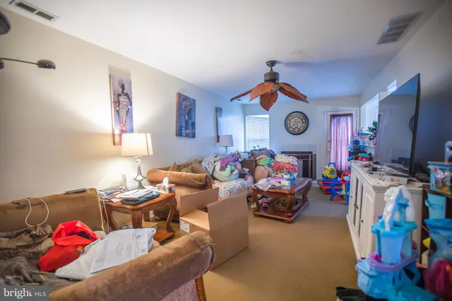 a bedroom with furniture and a fan