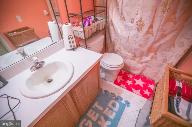a bathroom with a sink vanity and mirror