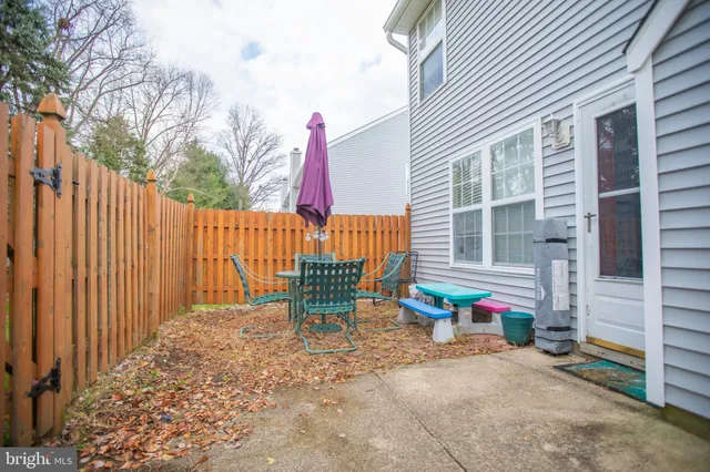 a view of a chairs and table in the backyard