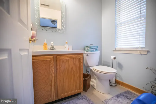 a white toilet sitting next to a bathroom sink