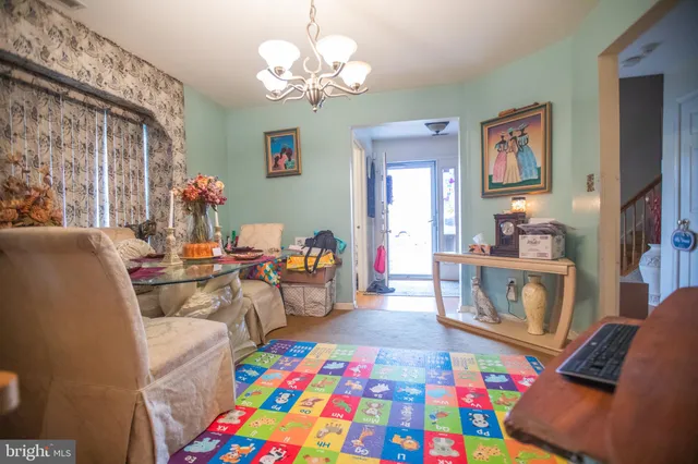 a living room with furniture and a baby crib