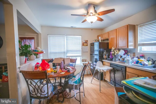 a view of a dining room with furniture and a potted plant