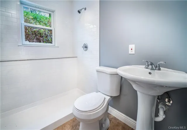 a kitchen with a sink cabinets and wooden floor