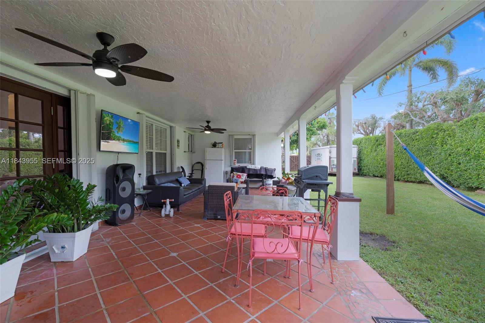 28401 Southwest 158th Court Homestead, FL 33033 - Photo 33 of 47 a living room with patio furniture and a fireplace
