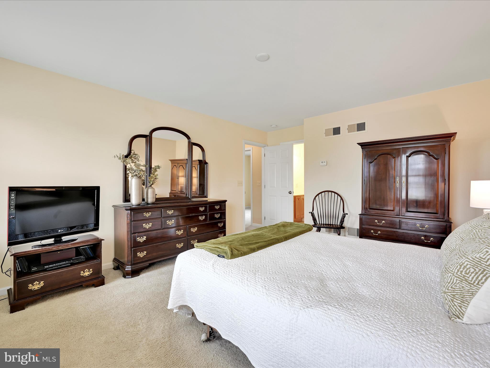 7 West Ridge Road Lititz, PA 17543 - Photo 18 of 40 a bedroom with a bed and a flat screen tv