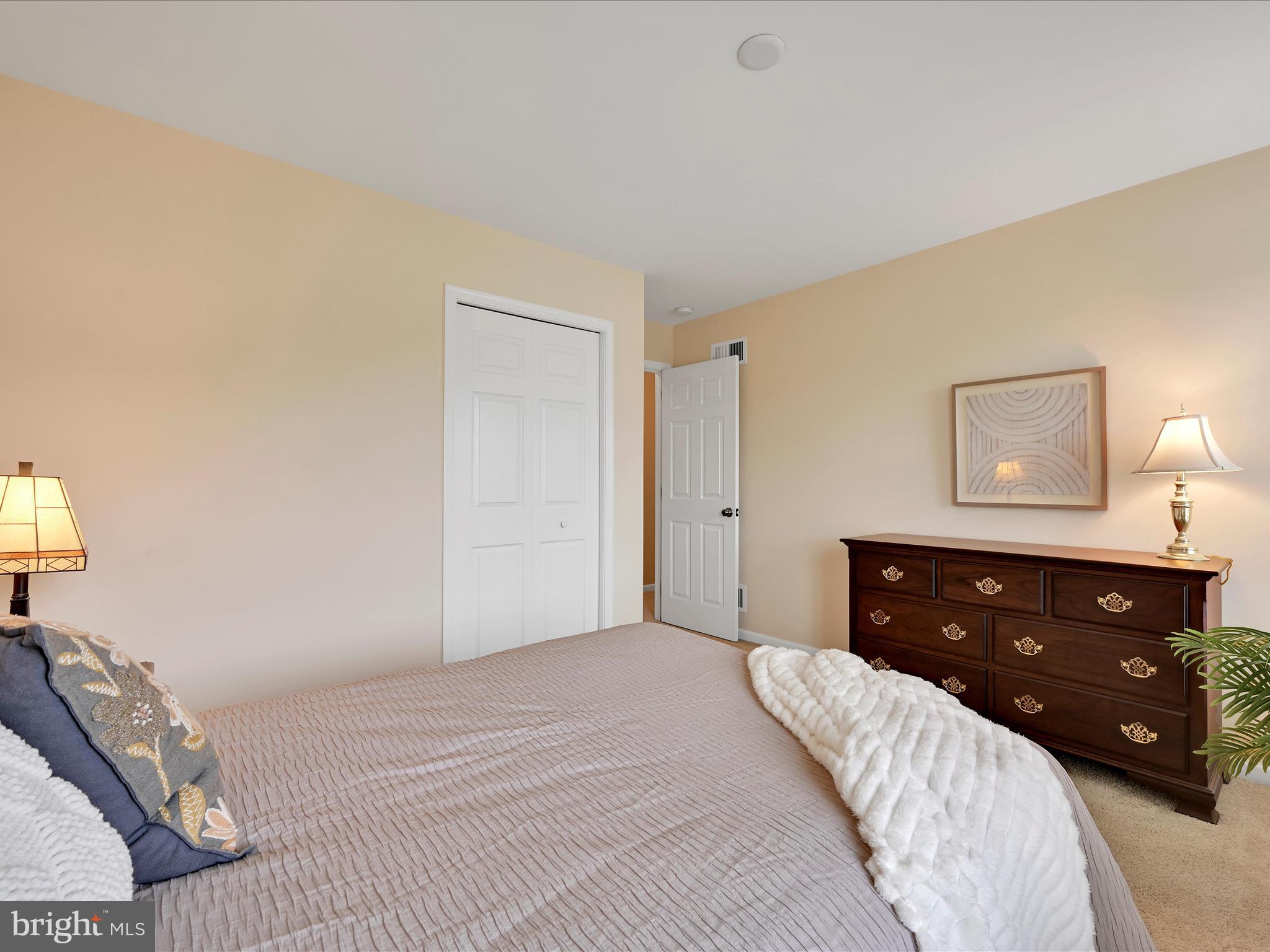 7 West Ridge Road Lititz, PA 17543 - Photo 24 of 40 a bedroom with a bed and a lamp on dresser