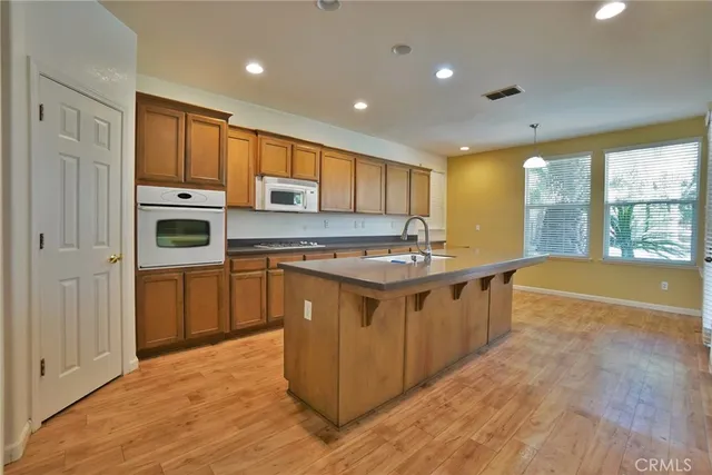 a kitchen with stainless steel appliances granite countertop a sink stove and microwave