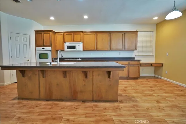 a bathroom with a granite countertop sink a mirror and a vanity