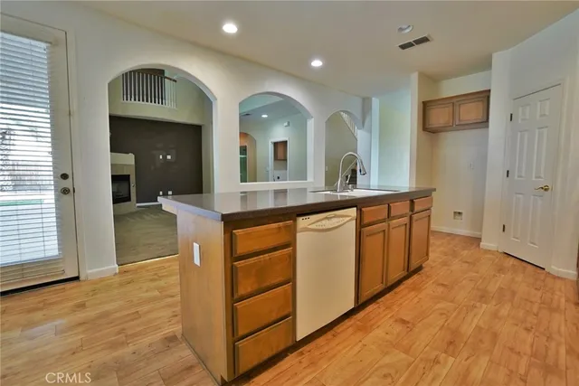 an empty room with windows and fireplace