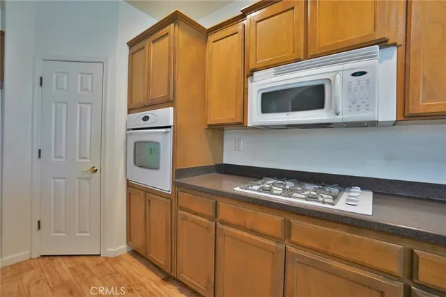 an empty room with a kitchen view and a window