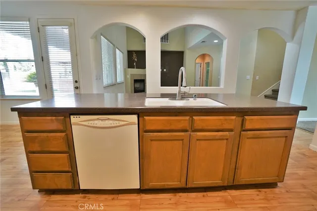 a view of empty room with wooden floor and cabinet