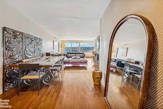a living room with dining room and wooden floor