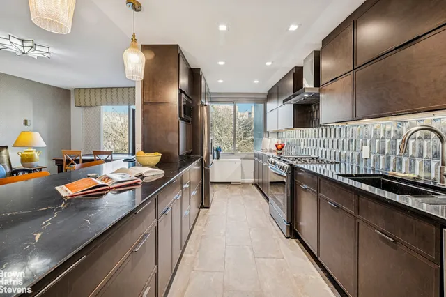 a kitchen with stainless steel appliances granite countertop a sink and stove