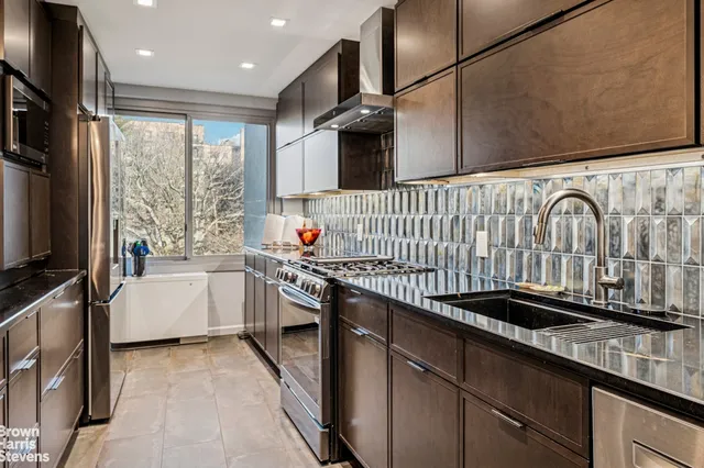a kitchen with stainless steel appliances a sink and a stove