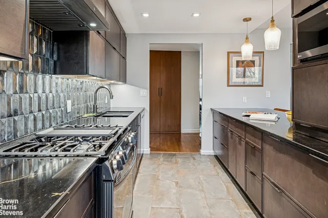 a kitchen with stainless steel appliances granite countertop a stove and a sink