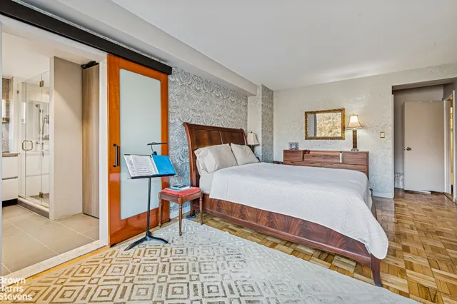 a bedroom with a bed and glass door