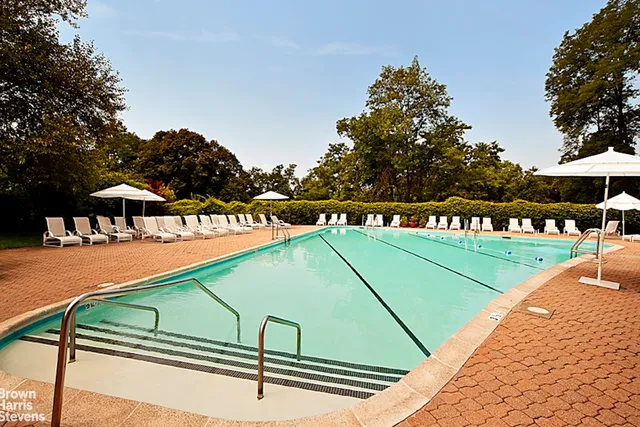a tennis court with trees in the background
