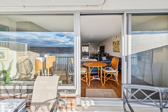 a dining room with a glass top table and chairs