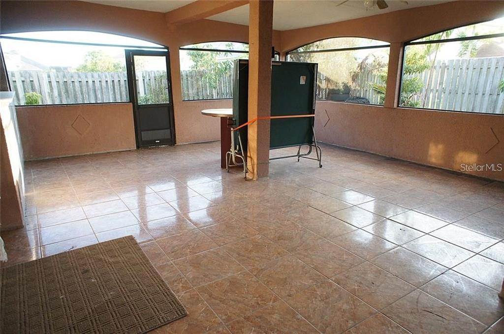 5948 Winchester Isle Road Orlando, FL 32829 - Photo 18 of 23 a living room with a large window and a rug