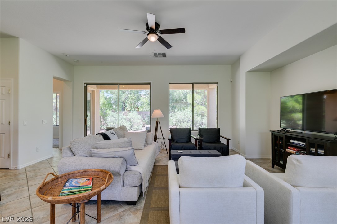8 Kennesaw Road Henderson, NV 89052 - Photo 13 of 44 The generously proportioned living room features ample space and access to the outdoor area through sliding doors.