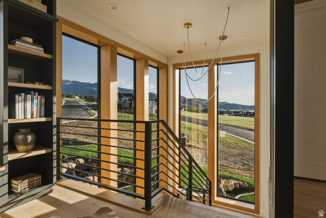 923 North Emery Lane Elk Ridge, UT 84651 - Photo 36 of 101 13' windows w/Modern staircase with black metal horizontal railings and light wood-finish flooring