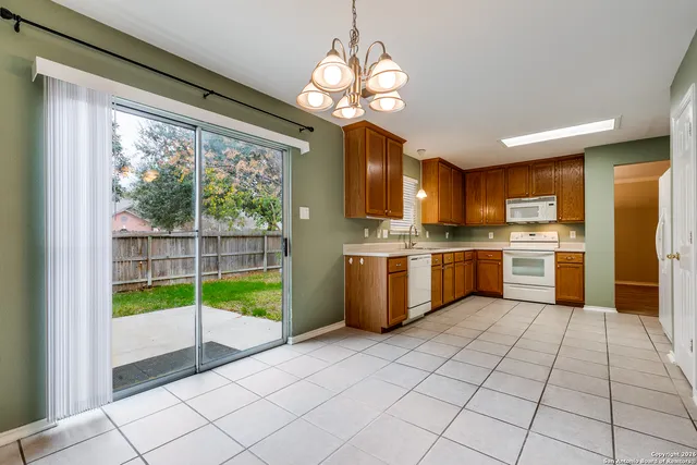 a kitchen with a sink a counter top space cabinets and stainless steel appliances
