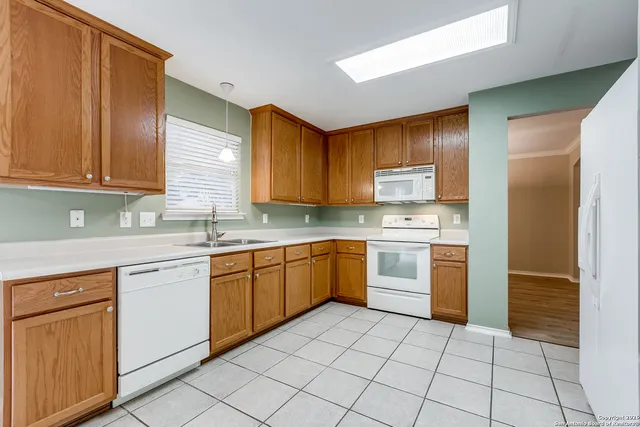 a kitchen with a stove top oven sink and cabinets