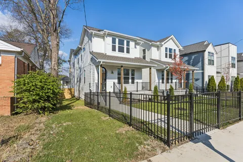 a view of a house with a small yard and plants