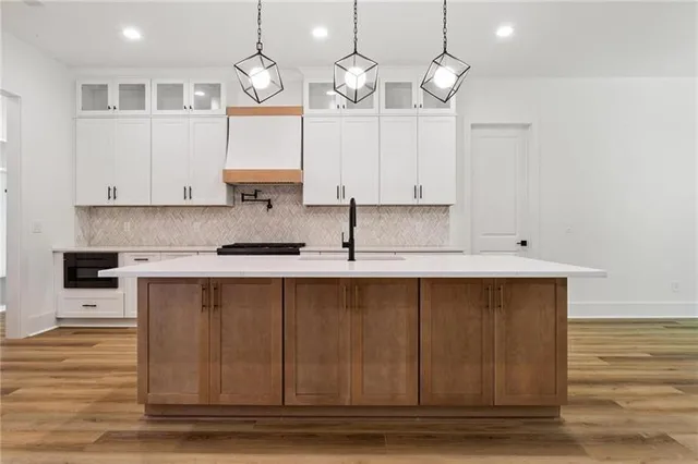a kitchen with cabinets a sink and appliances