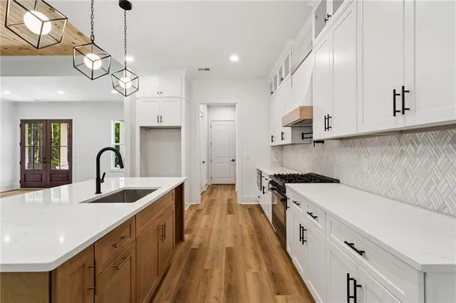 a kitchen with a sink appliances and a large window