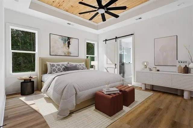 an empty room with wooden floor closet and windows