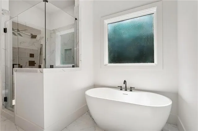 a bathroom with a granite countertop sink vanity mirror and shower