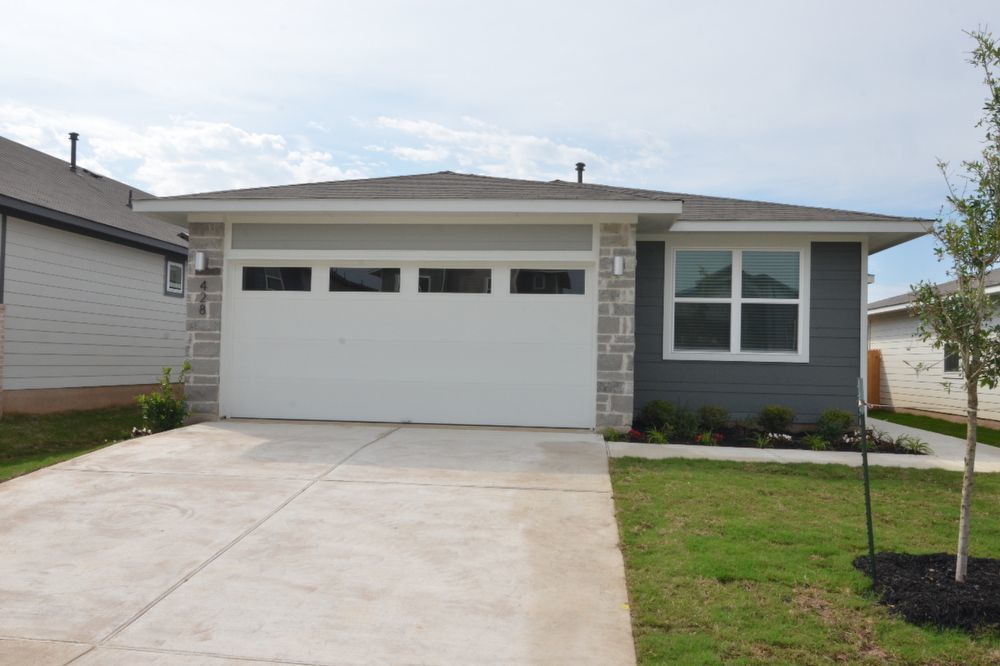 428 Agave Azul Way Leander, TX 78641 - Photo 2 of 24 Clean lines and a spacious driveway define this modern single-story elevation.