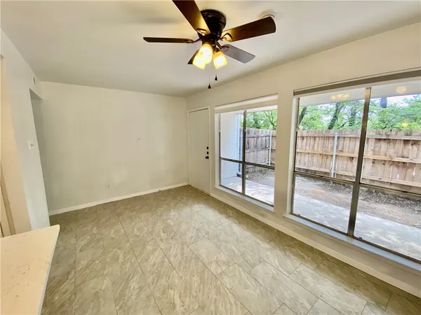 a view of a livingroom with a ceiling fan and window