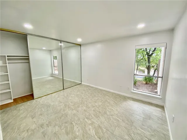 an empty room with a empty space and windows