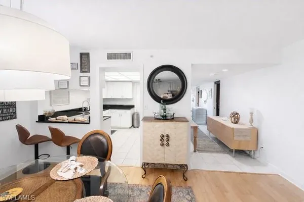 a kitchen with stainless steel appliances granite countertop a sink a stove and white cabinets