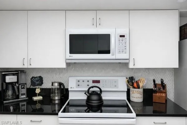 a dining room with furniture and a mirror