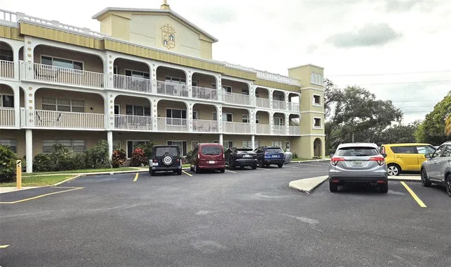 a view of a street with cars and a buildings