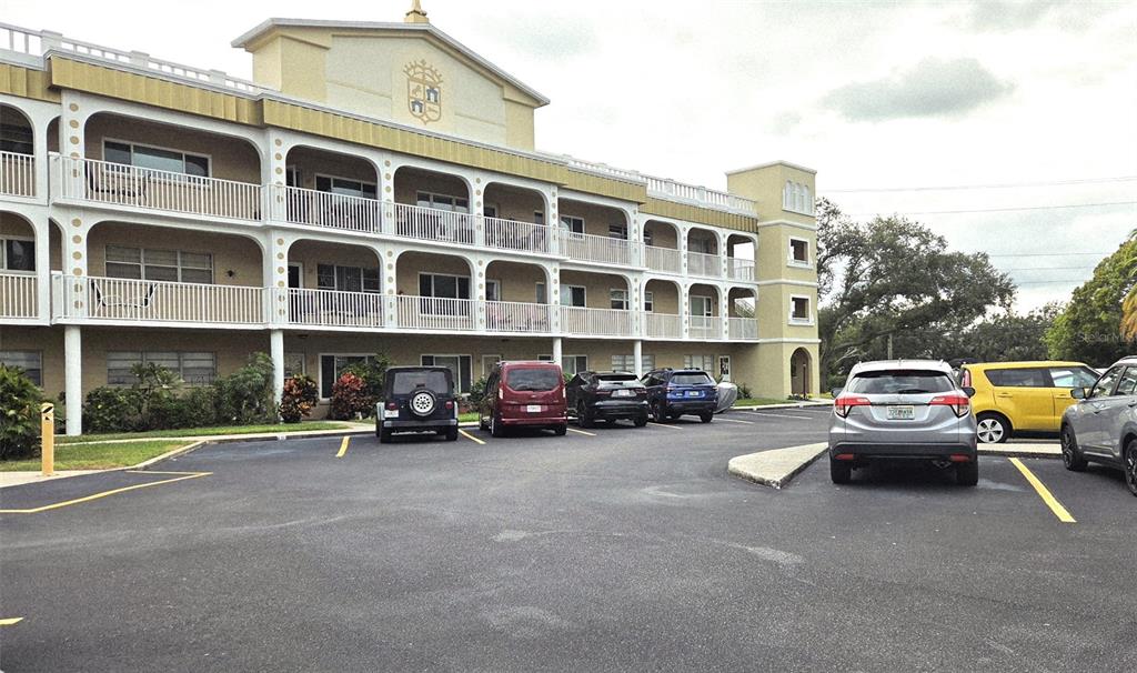 a view of a street with cars and a buildings