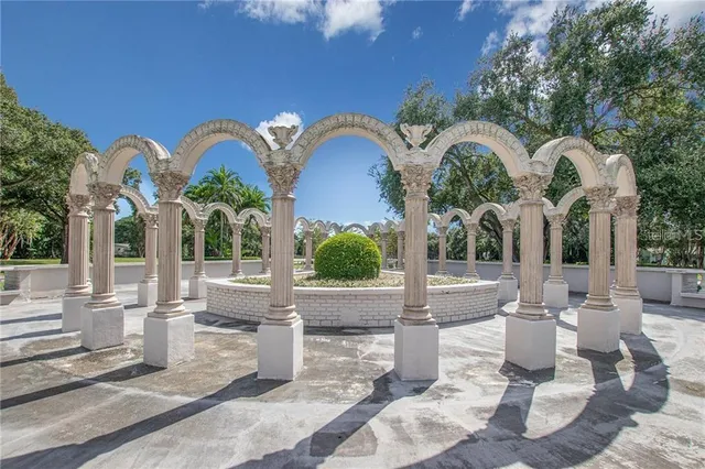 a view of swimming pool with outdoor seating and plants