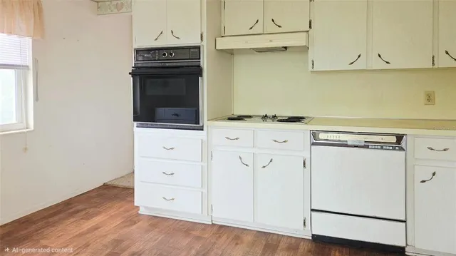 a kitchen with granite countertop white cabinets and white appliances