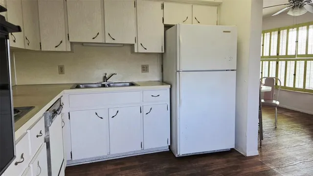 a kitchen with a refrigerator a sink and dishwasher