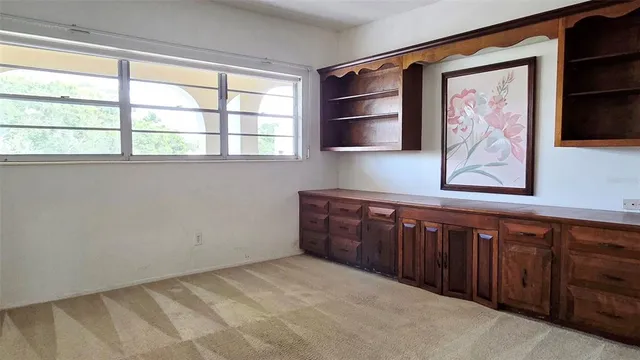 a room with a bed and a painting on the wall